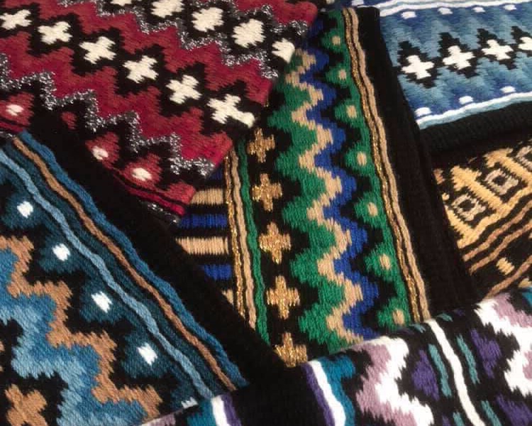 Close up of six unique saddle blanket designs featuring bold yarn colours and metallic threads
